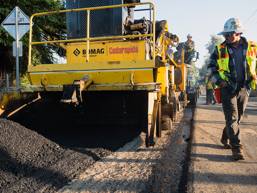 spreading asphalt on new road