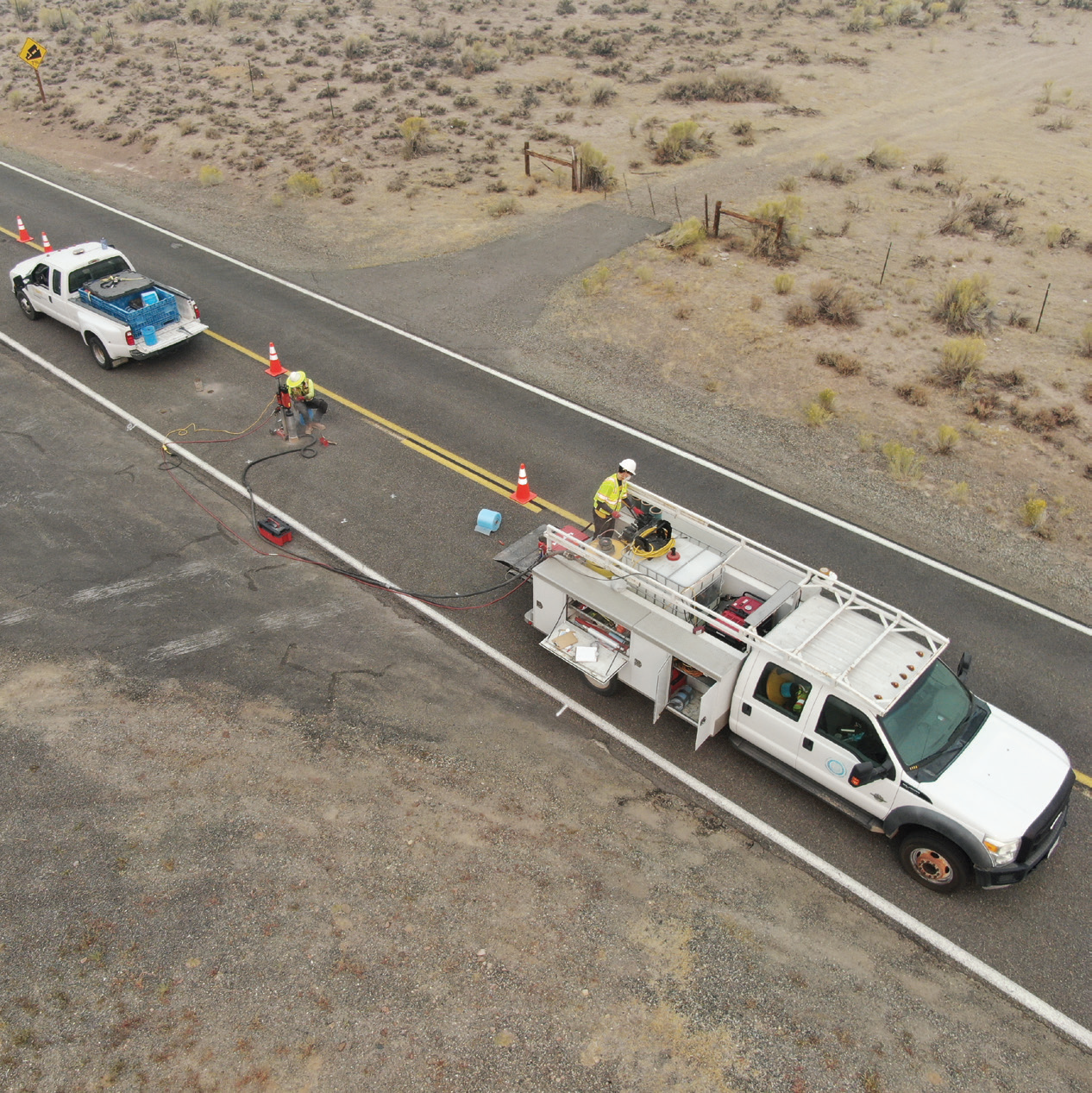 Survey crew conducting pavement condition data collection on a roadway for use in management systems.