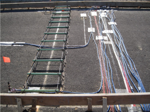UCPRC field crew installing instrumentation on a live pavement test section for long-term performance monitoring.