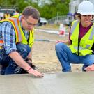 professors studying concrete pour